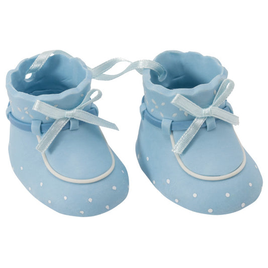 Close-up of blue plastic baby booties with ribbon laces and white polka dots