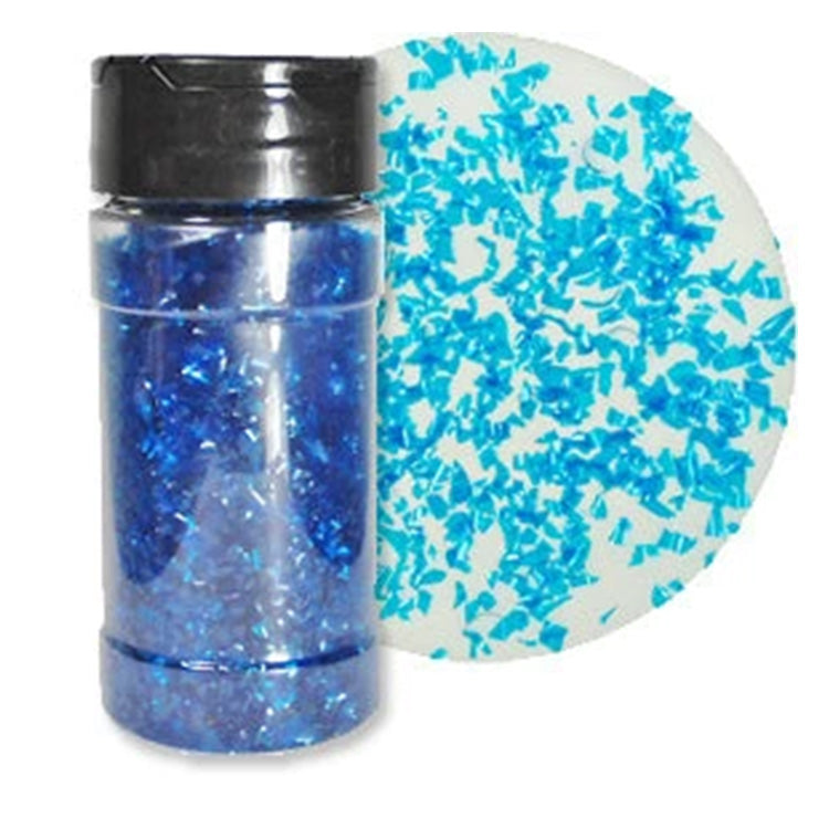 Clear shaker bottle filled with bright blue edible glitter flakes beside a white round sample scattered with vivid blue shimmering flakes.