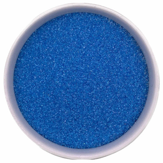 Bowl of bright blue fine sanding sugar crystals on a white background.