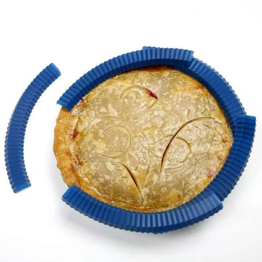 Blue silicone pie crust shield placed around a baked pie.