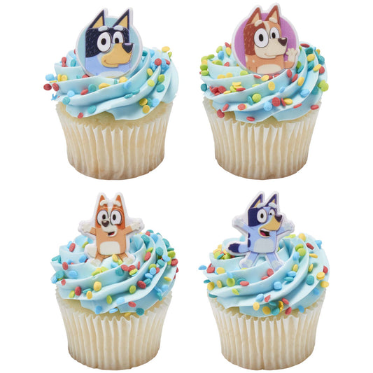 Bluey, Bingo, Bandit, and Chilli cupcake rings displayed on four blue-frosted cupcakes with colorful sprinkles