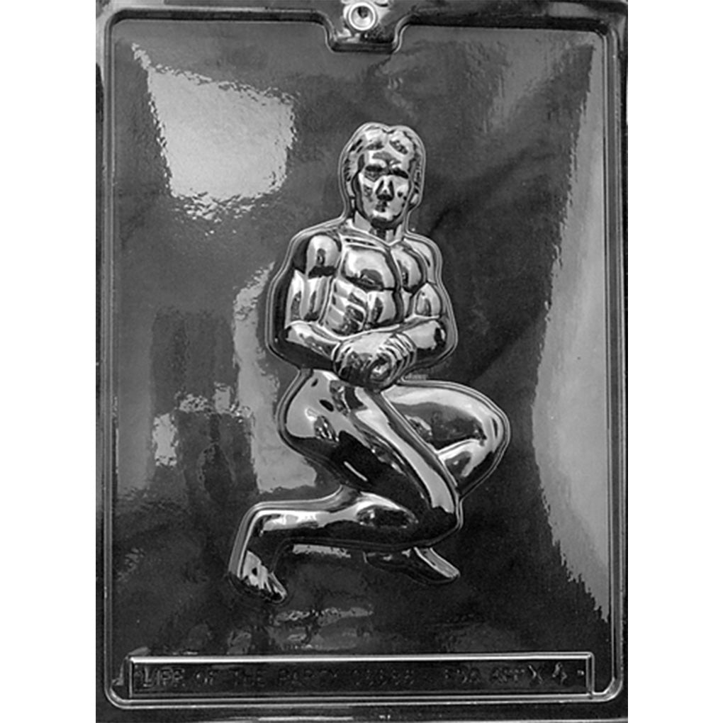 Clear Macho Man Chocolate Mold photographed against a dark background, showing one large cavity of a muscular kneeling man with defined abs, broad shoulders, and sculpted facial details.