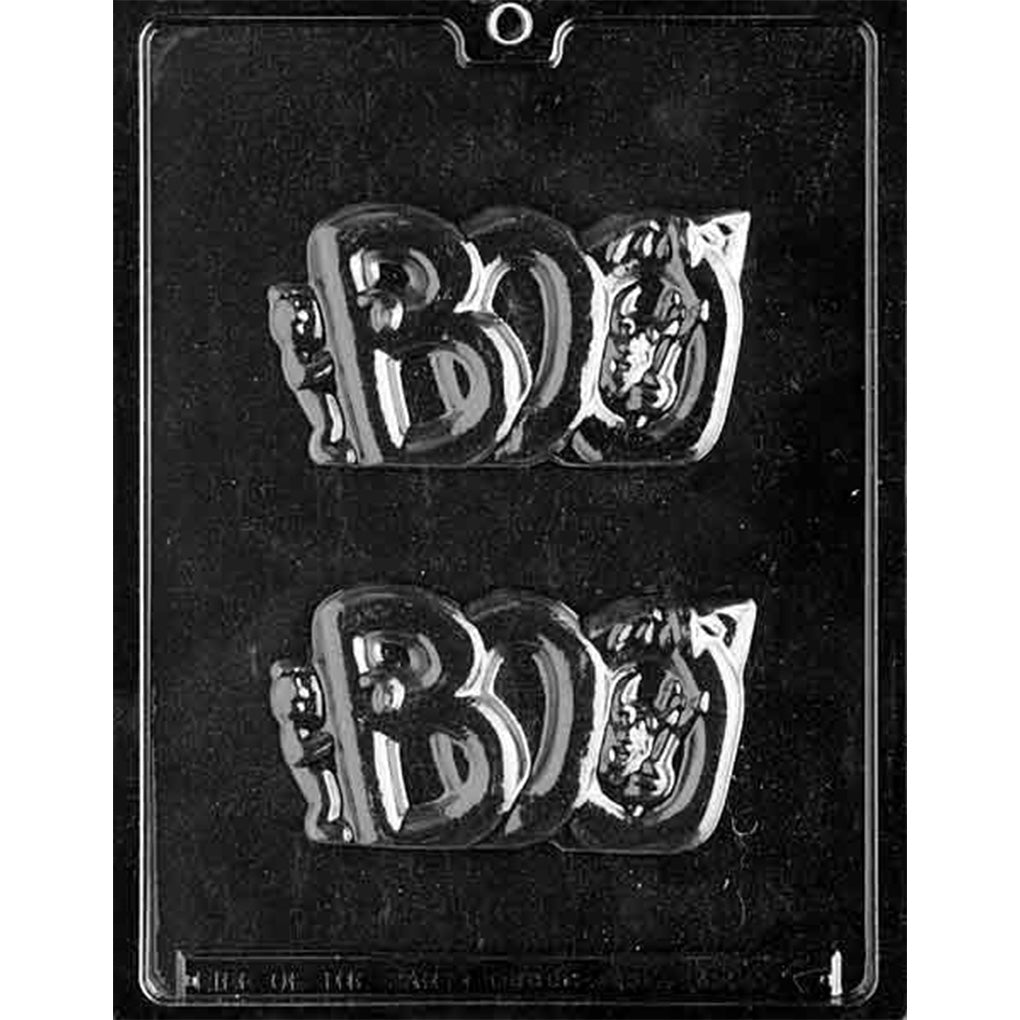 Clear plastic chocolate mold photographed on a black background with two large BOO-shaped cavities, each showing raised letters with small Halloween character details including a devil figure with a pitchfork.
