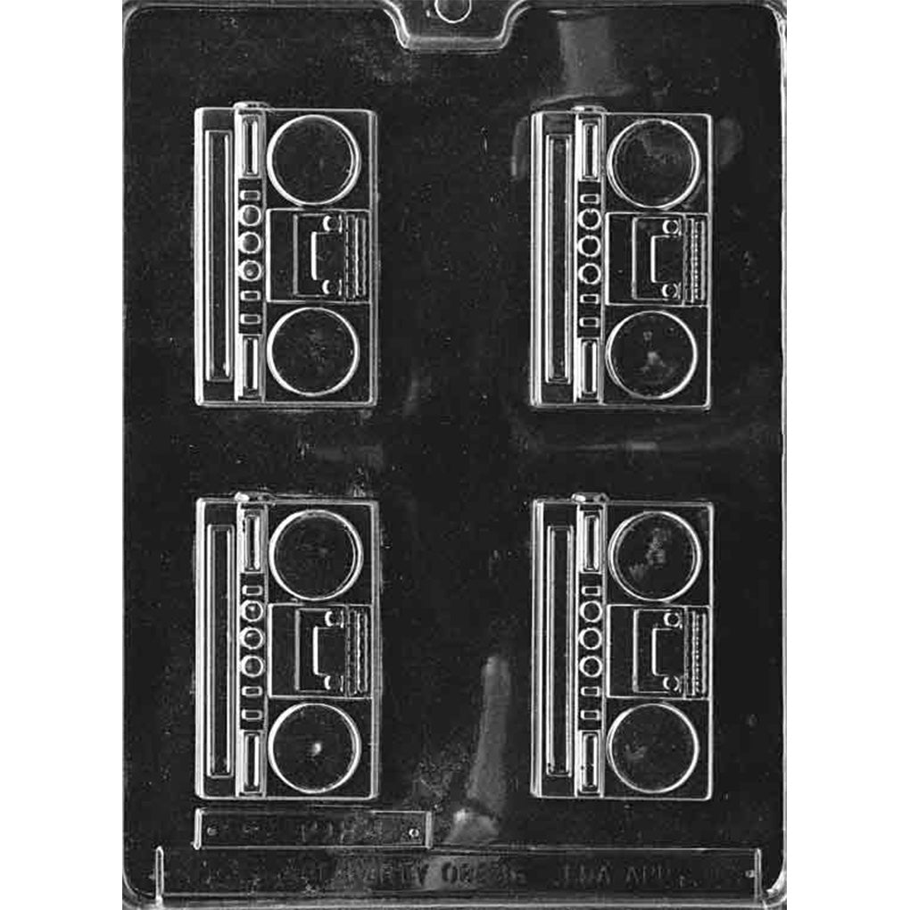 Clear plastic chocolate mold with four retro boombox cavities, each showing two round speaker circles, a central rectangular panel, and small button details along the side.