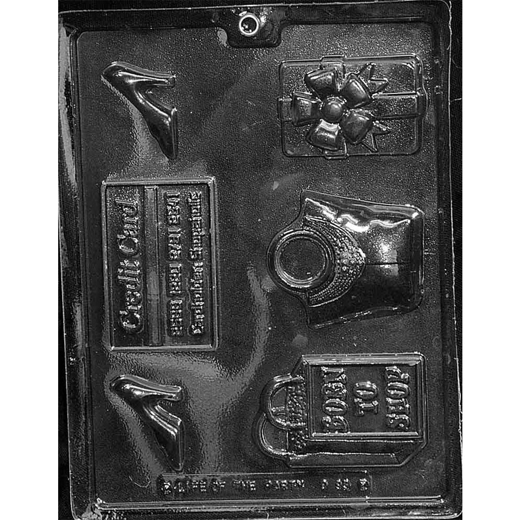 Clear plastic chocolate mold photographed on a dark background with assorted shopping-themed cavities including a high-heeled shoe, bow-topped gift box, credit card plaque, vintage handbag, and a shopping bag that says “BORN TO SHOP.”