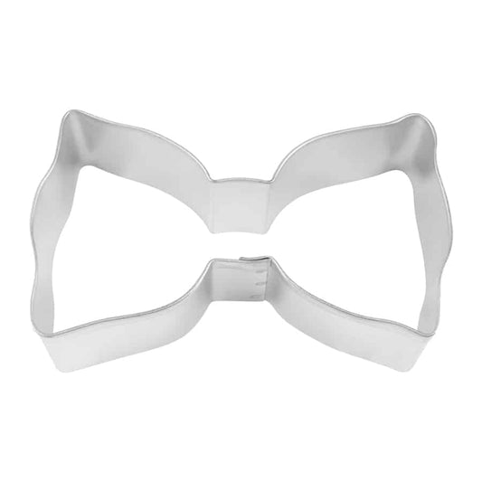 Top-down view of a metal bow tie cookie cutter with smooth curves