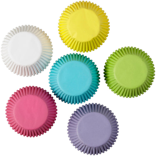 Top view of six pastel baking cups arranged in a circle, each a different color.
