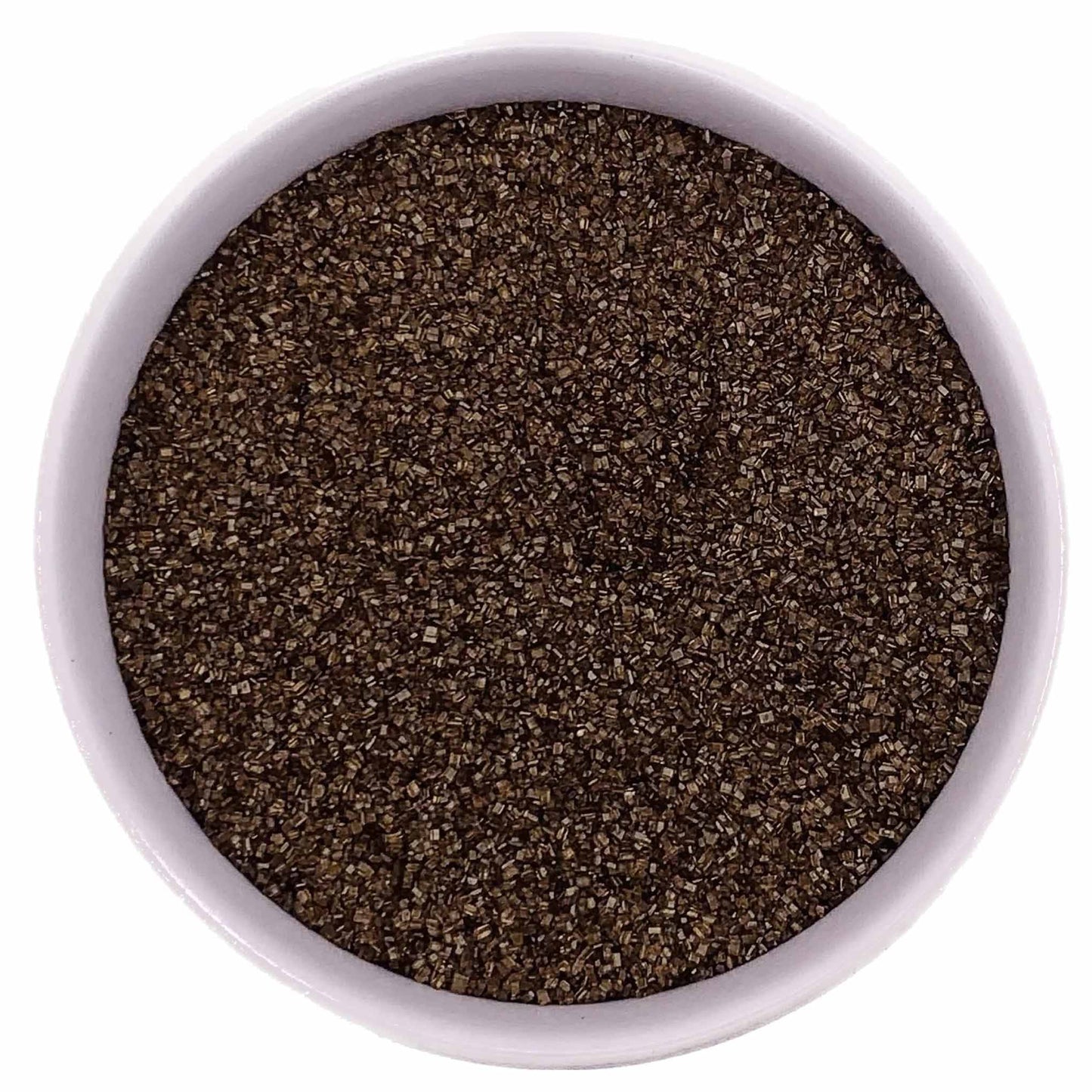 Brown fine sanding sugar crystals in a white bowl on a white background.