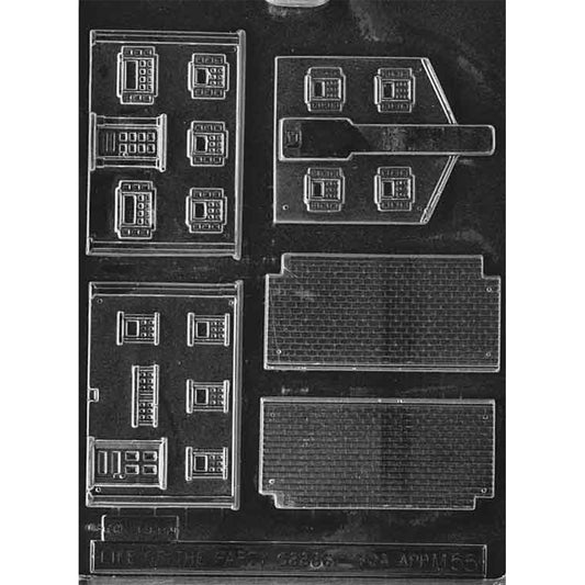 Clear plastic chocolate mold with colonial house building panel cavities, including wall sections with multiple window outlines and roof panels with a shingle pattern for assembling a 3D chocolate house.