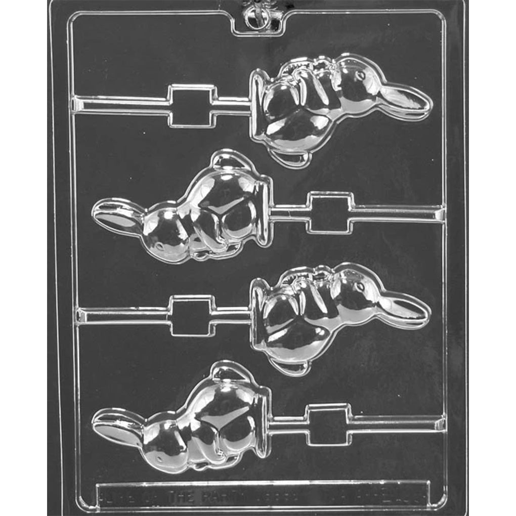 Clear plastic chocolate lollipop mold with four cavities shaped like a side-profile bunny holding a carrot, with a long ear extending behind the head and a stick channel attached to each cavity.