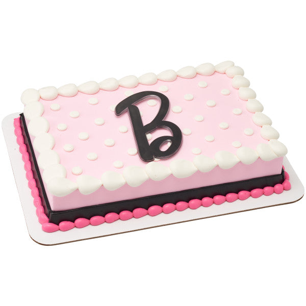 Pink and white polka dot cake decorated with a black "B" lay-on topper from the Barbie Lay-on Cake Topper set.