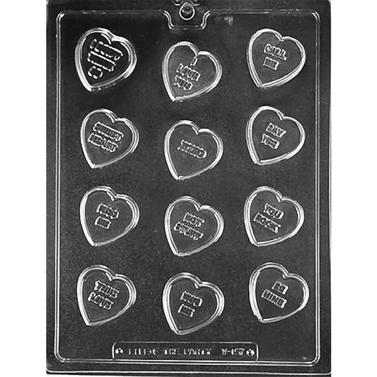 Clear chocolate mold with 12 small heart-shaped cavities, each featuring a raised phrase such as Be Mine, XOXO, Kiss Me, or Hot Stuff.