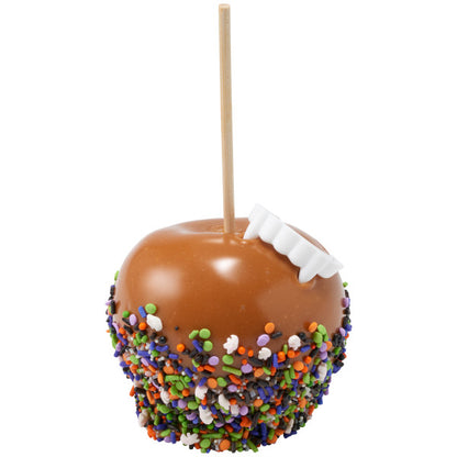 A caramel-dipped apple coated with a Halloween sprinkle blend, featuring vibrant colors and topped with ghost-shaped quins, pearls, and assorted sprinkles.