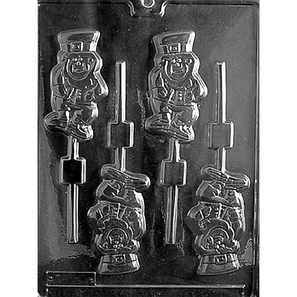 Clear plastic chocolate lollipop mold with four leprechaun-shaped cavities featuring a hat, coat, and facial details, plus stick channels for making St. Patrick’s Day chocolate pops.