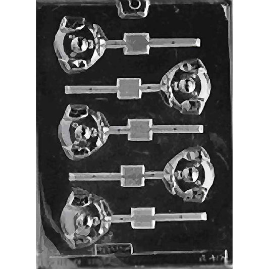 Clear plastic chocolate lollipop mold with five pig face cavities, each showing a smiling cartoon pig with floppy ears, a round snout, and a bowtie, with stick channels; shown on a dark background.