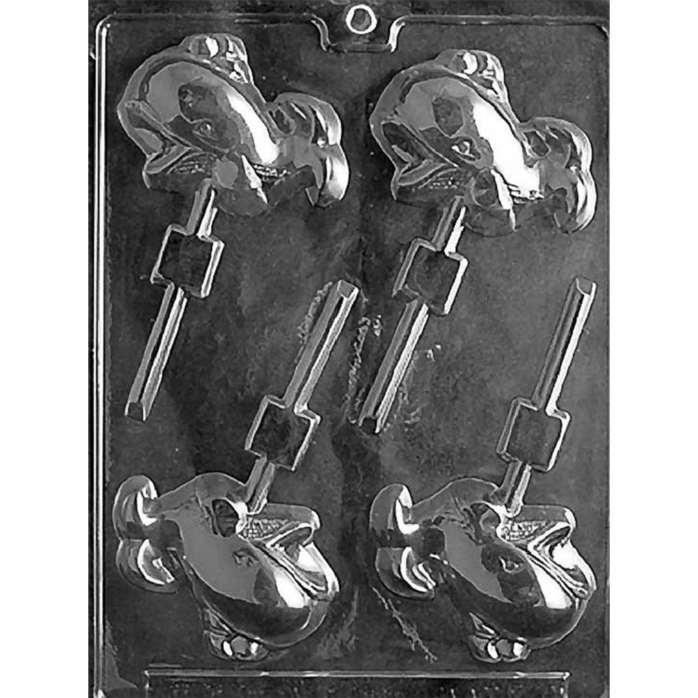 Clear plastic chocolate lollipop mold photographed on a black background, with four cartoon whale-shaped cavities and stick channels for making whale chocolate pops.