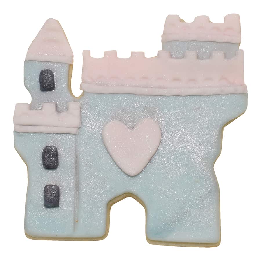 Decorated castle cookie with pastel icing, glitter details, and a heart centerpiece.