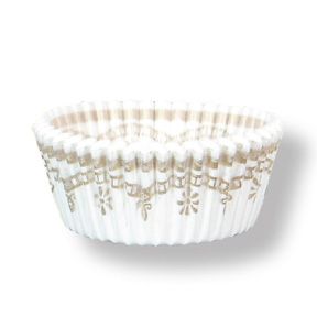 White paper cupcake liner with gold floral design on a white background