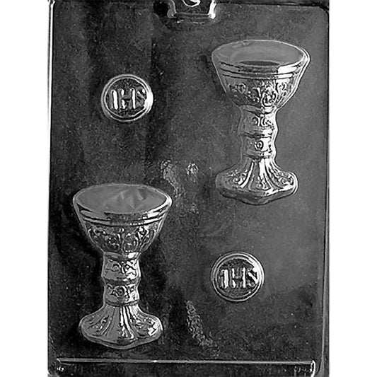 Clear plastic chocolate mold photographed on a black background with two chalice-shaped cavities and two small round host medallion cavities with IHS lettering.