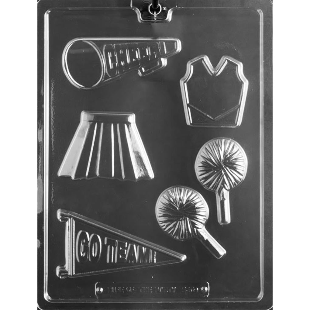 Clear Cheerleader Assortment Chocolate Mold photographed against a dark background with cavities shaped like a megaphone, cheer top, pleated skirt, two pompoms, and pennant.