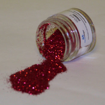 Bright cherry red Galaxy Glitter Dust labeled "Cherry," spilled from a jar, sparkling vividly against a white backdrop.
