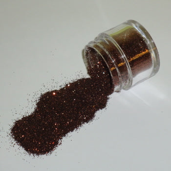Rich chocolate brown Galaxy Glitter Dust spilling from a clear jar, shimmering with coppery undertones against a white background.