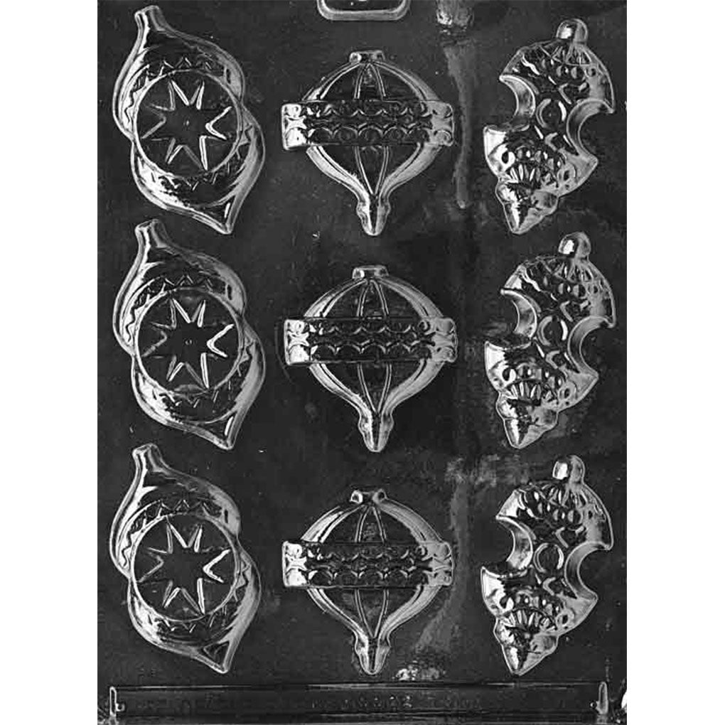 Nine-cavity Christmas ornament chocolate mold with three pointed starburst ornaments, three round banded finial ornaments, and three scalloped crescent-pattern ornaments.