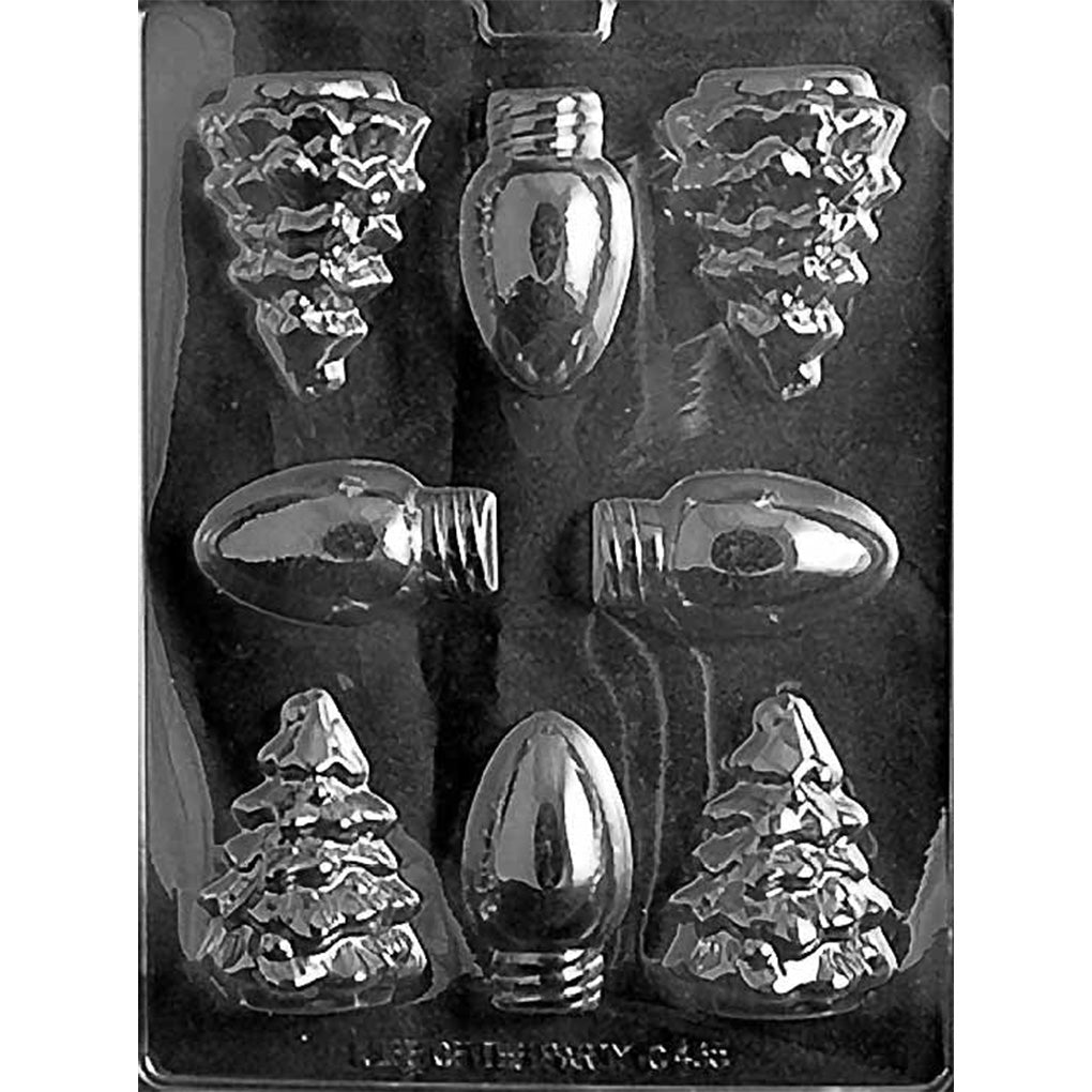Clear plastic chocolate mold with assorted Christmas-themed cavities shaped like evergreen trees and classic holiday light bulbs in several styles, shown on a dark background.