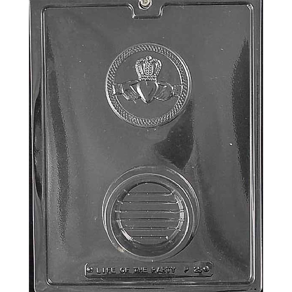 Claddagh pour box chocolate mold with two large round cavities in clear plastic, one embossed with a Claddagh symbol featuring a heart, hands, and crown, and one smooth round base cavity.