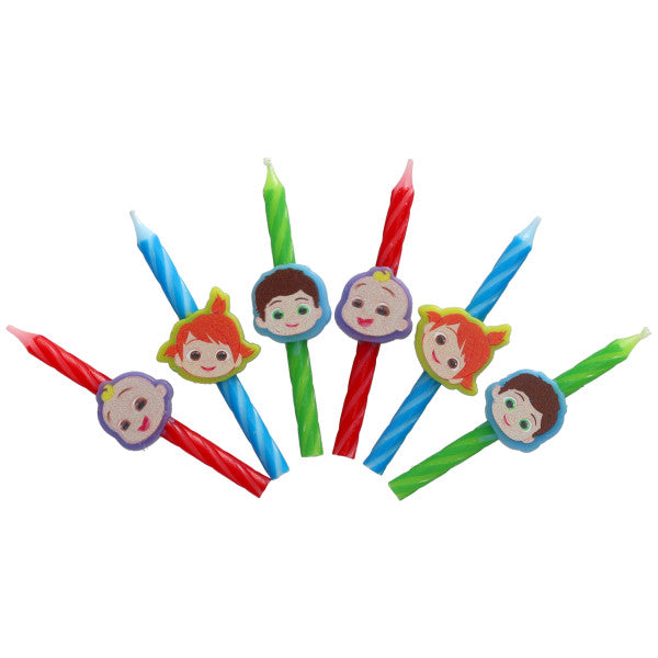 CoComelon birthday candles featuring JJ, Nico, and TomTom character toppers on red, blue, and green spiral candles, displayed in a scattered fan shape.