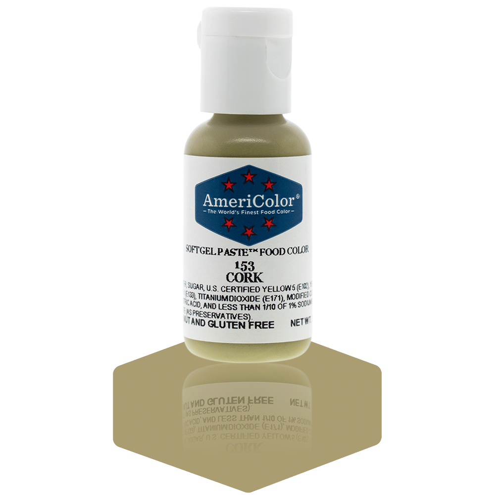  A bottle of AmeriColor Cork soft gel paste food coloring with a white cap, blue label, and red stars, positioned on a cork-colored reflective surface with the bottle’s reflection clearly visible.