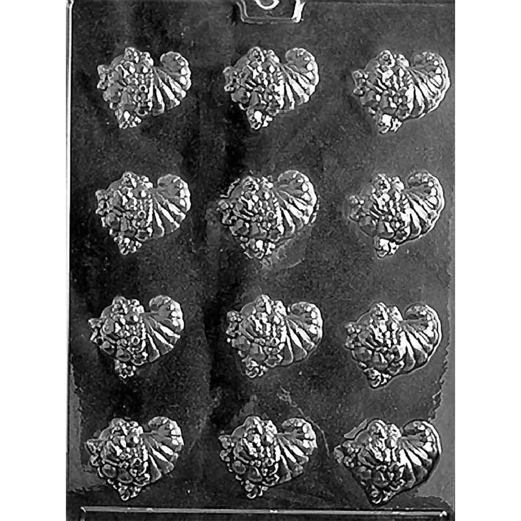 Clear plastic chocolate mold with twelve mini cornucopia cavities featuring detailed ridges and harvest horn shapes, photographed on a dark background.