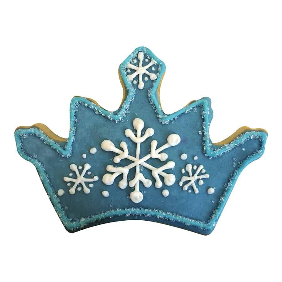 Decorated crown-shaped cookie with blue icing and white snowflake details.