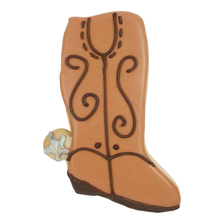 Decorated cowboy boot-shaped cookie with brown icing, black stitching details, and a silver spur.