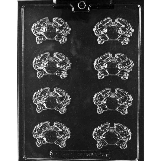 Clear Crab Pieces Chocolate Mold photographed against a black background with eight small crab-shaped cavities showing raised claws, shells, and legs.