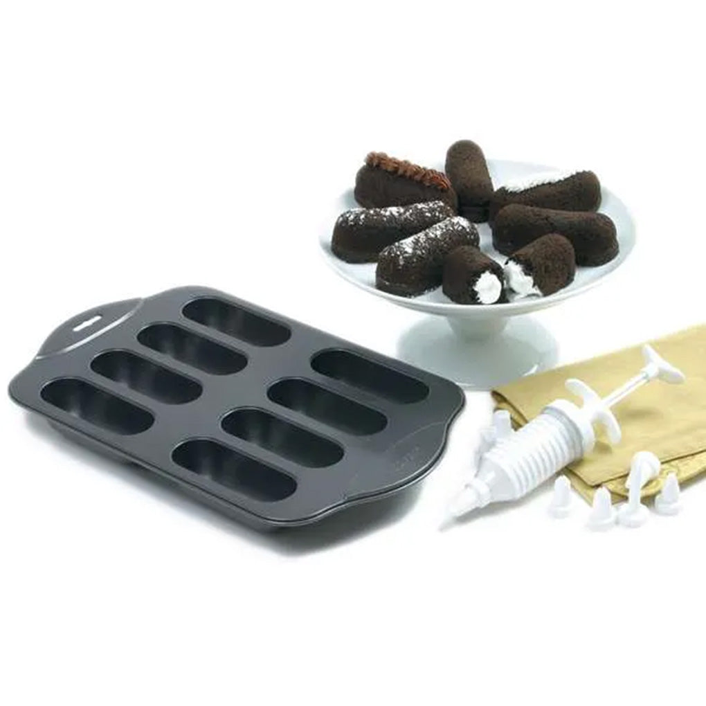 Cream Canoe baking pan with chocolate and vanilla snack cakes plus filling injector and decorating tips.