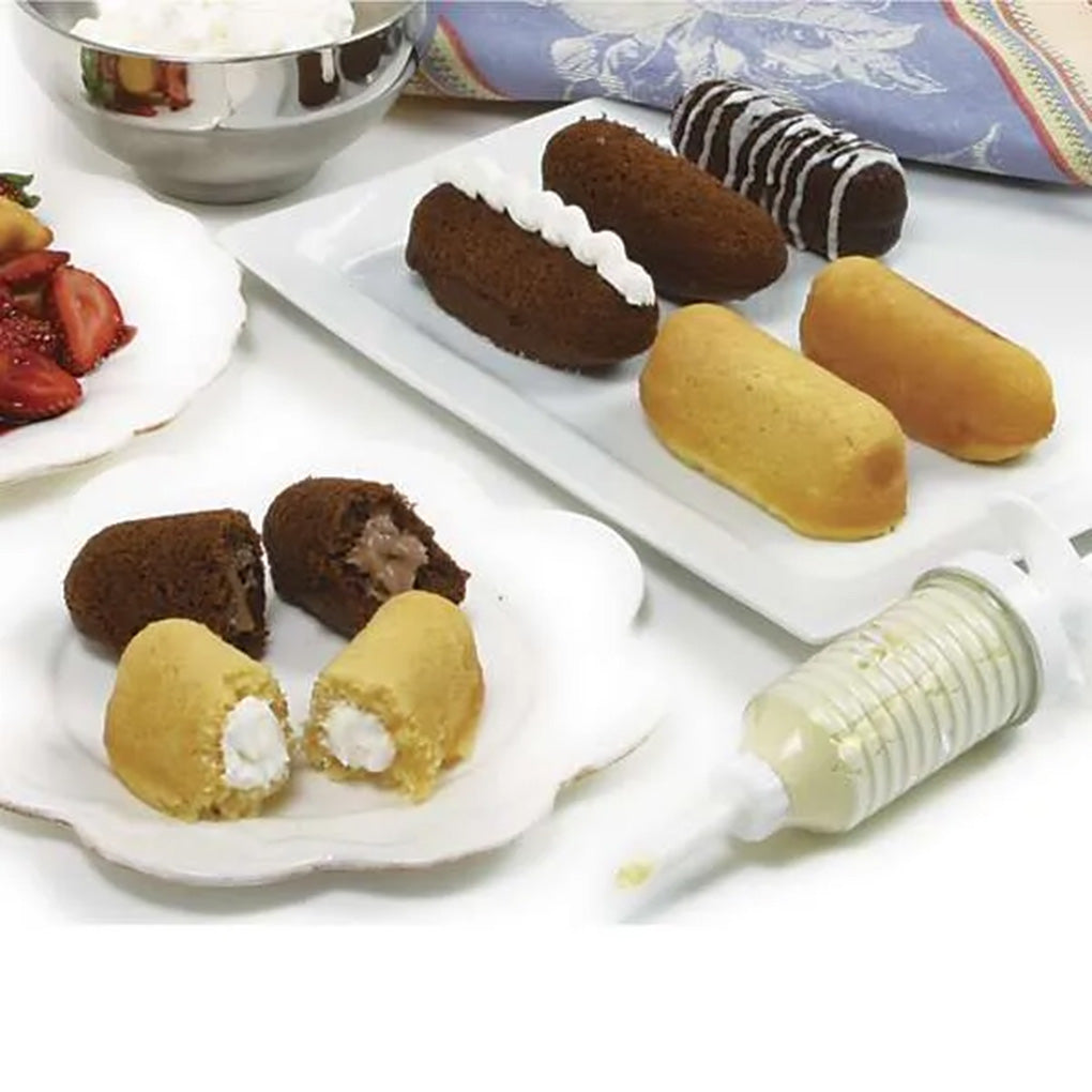 Homemade vanilla and chocolate cream canoe snack cakes filled with cream and chocolate filling, shown with the filling injector.