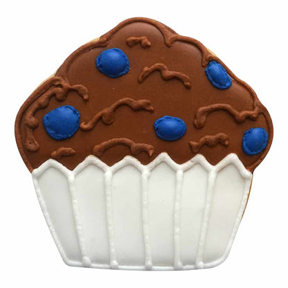 Muffin-shaped cookie decorated with brown icing, blue candy details, and a white cupcake liner design.