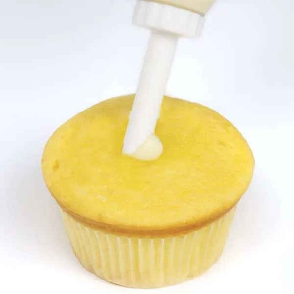 Adding filling to cupcake using injector.