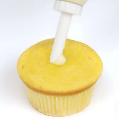 Adding filling to cupcake using injector.