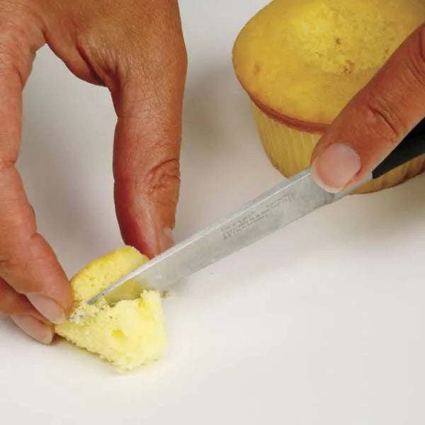 Slicing cupcake top for reinsertion.