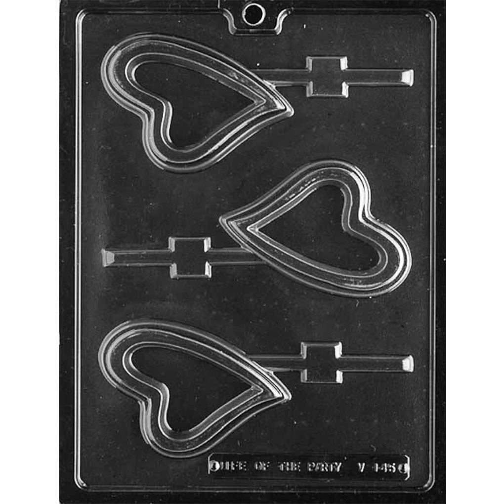 Clear chocolate lollipop mold with three large curved heart-shaped cavities and straight stick channels, shown against a dark background.