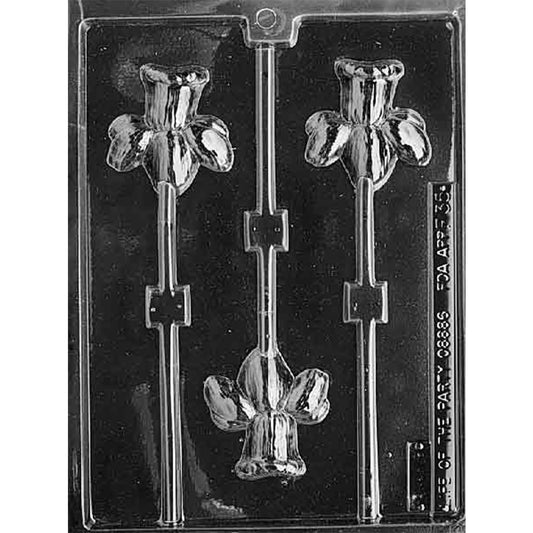 Clear plastic chocolate lollipop mold with three daffodil flower cavities, each showing a flared trumpet center, rounded petals, and a stick channel for flower-shaped chocolate pops.