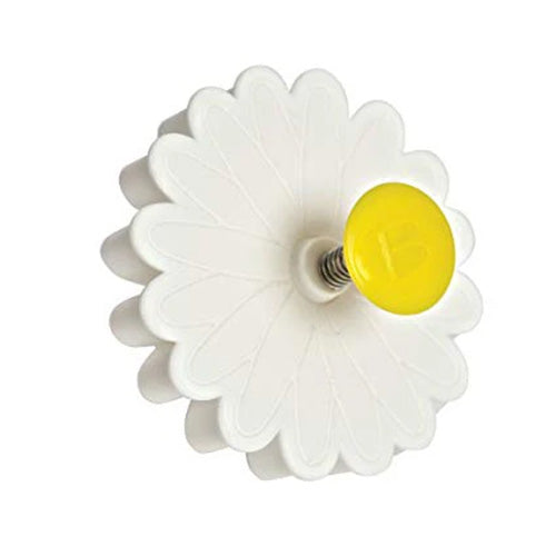 Side view of a white daisy-shaped plunger cutter with a yellow round button and visible metal spring against a white background.