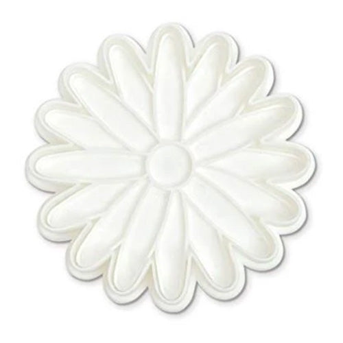 Top view of a white daisy-shaped stamp cutter showing petal outlines and a round center on a white background.