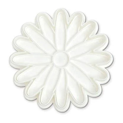 Top view of a white daisy-shaped stamp cutter showing petal outlines and a round center on a white background.