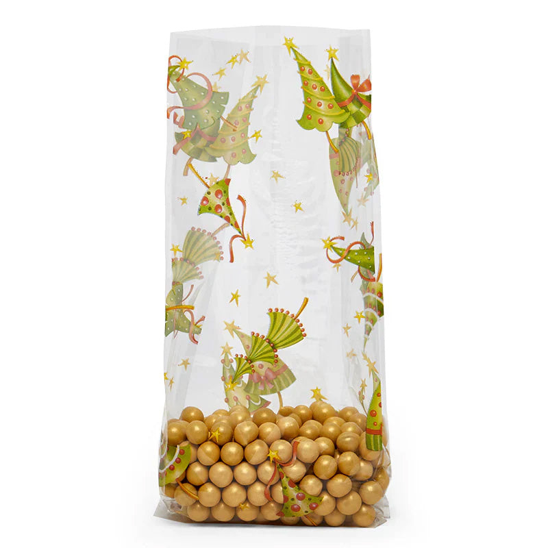Clear gusseted cellophane treat bag printed with green cartoon Christmas trees and small gold stars, shown standing upright with gold candy balls at the bottom.