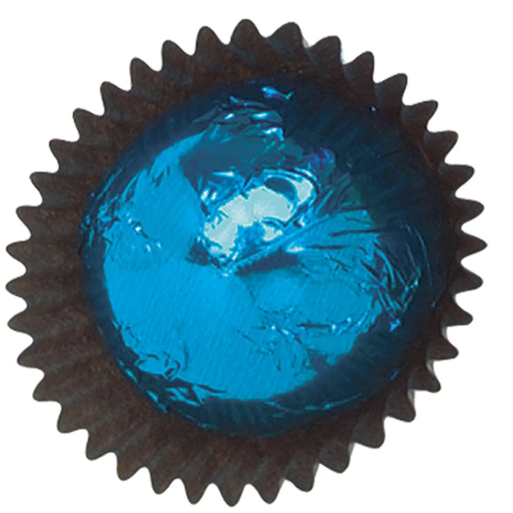 Close-up of a blue foil-wrapped chocolate in a dark brown paper candy cup, showing shiny crinkled foil on a white background.