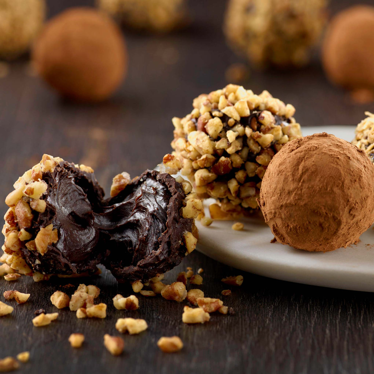 Dark chocolate truffles made with ganache centers and finished with assorted chocolate coatings and toppings.