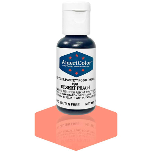 A bottle of AmeriColor Desert Peach soft gel paste food coloring, showcasing a white cap and blue label with red stars, placed on a shiny peach surface that reflects the bottle.